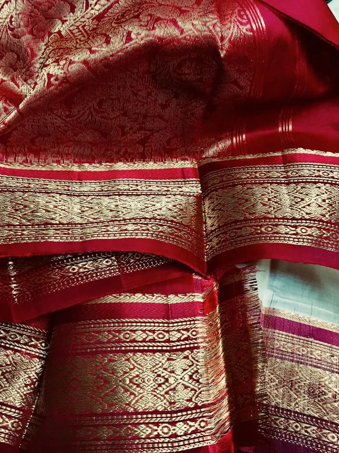 Close detail of a red and gold zari saree border