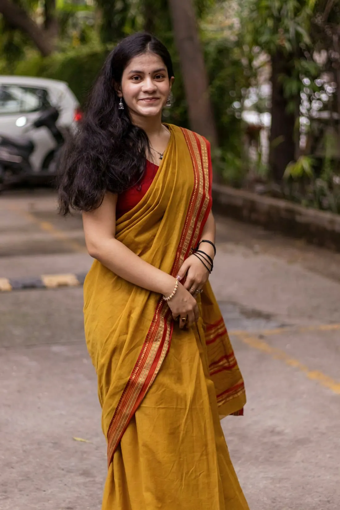 A woman in a mustard cotton saree
